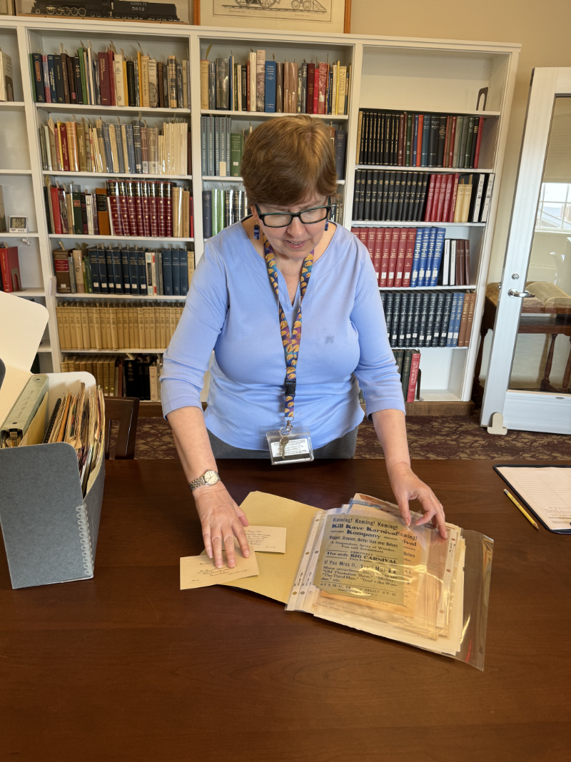 SMU Archivist Joan Gosnell rifles through historic documents in Fondren Library.